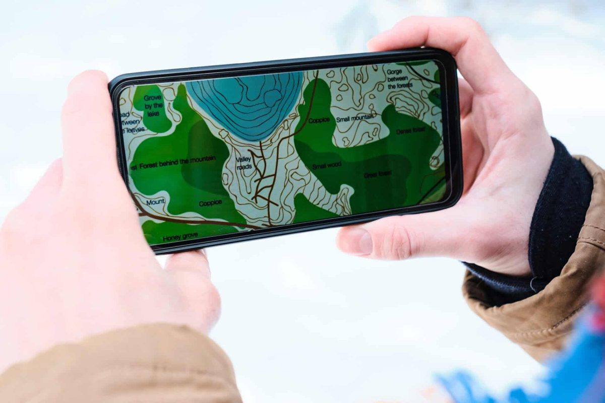 Using Map App On Smartphone Close-up shot of unrecognizable person holding smartphone with both hands reading map on screen